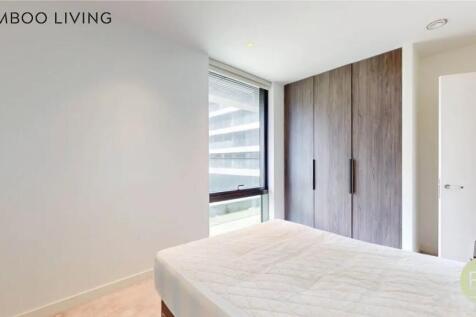 Bright double bedroom featuring a large window ...