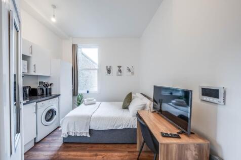 This inviting double bedroom features a cozy la...