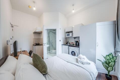 This inviting double bedroom features a cozy la...