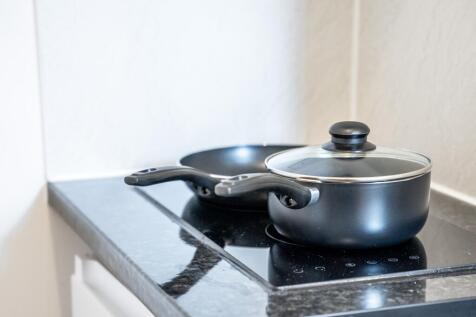 A modern kitchen setup featuring a sleek black ...