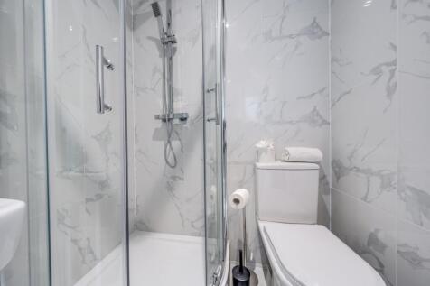 Contemporary bathroom featuring sleek marble wa...