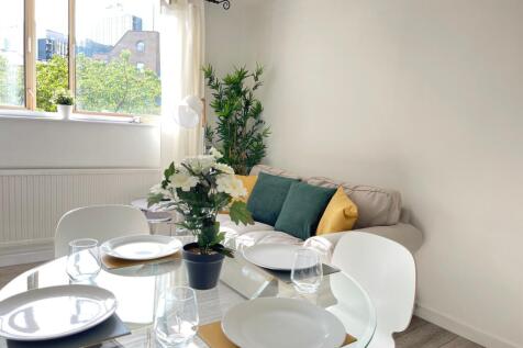 A bright and inviting large modern living room ...