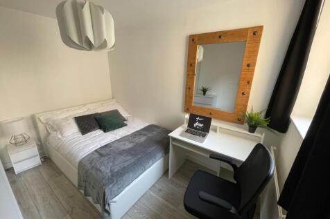 A bright and inviting double bedroom featuring ...