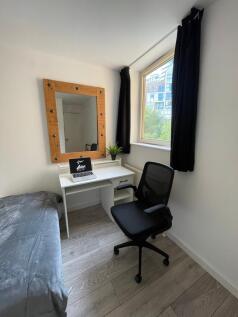 A bright and inviting double bedroom featuring ...