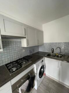 A modern and tidy kitchenette equipped with ess...