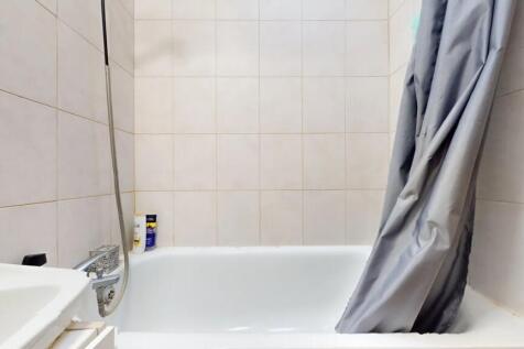 A clean and functional bathroom suite featuring...