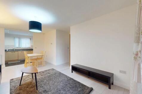 A bright and modern living room featuring a coz...