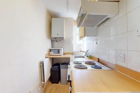 A compact kitchen featuring essential appliance...