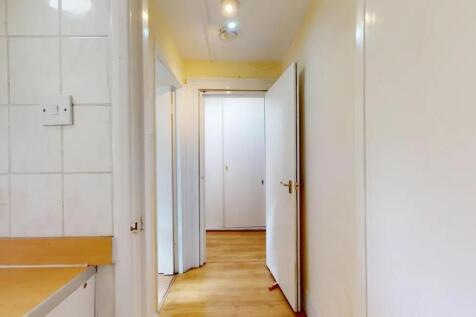 A clean and simple hallway with wooden flooring...