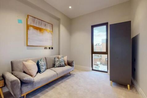 A stylish and cozy living room featuring a comf...