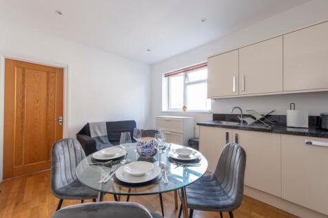 A bright and modern kitchenette with a stylish ...