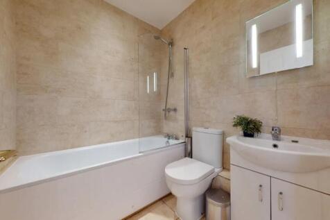 Modern bathroom suite featuring a clean white b...