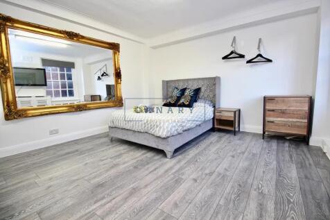 A stylish master bedroom featuring a plush doub...