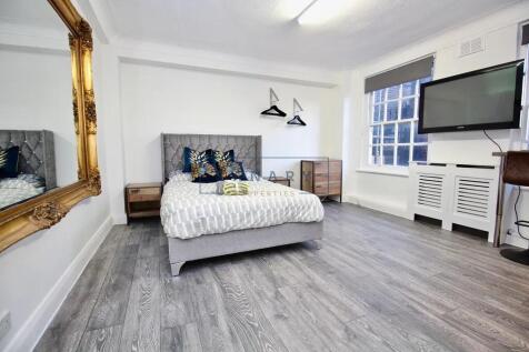 A bright and modern double bedroom featuring a ...