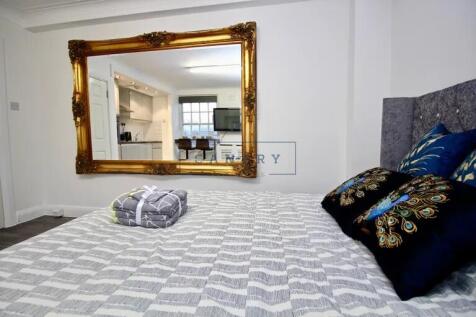 A stylish double bedroom featuring a large comf...
