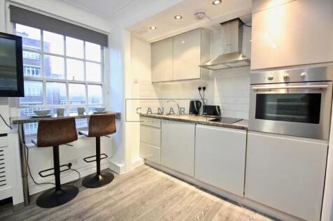Bright and modern kitchen featuring sleek white...