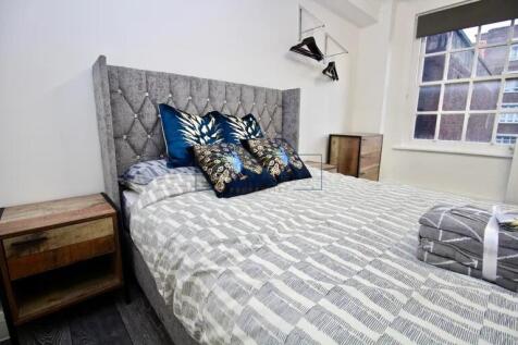 Bright and cozy double bedroom featuring a styl...