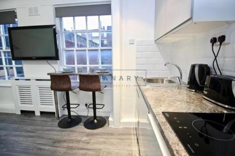 Bright and modern kitchen area featuring a slee...