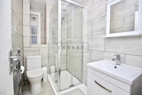 Bright and modern bathroom featuring a walk-in ...