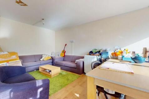 A bright living room featuring ample natural li...