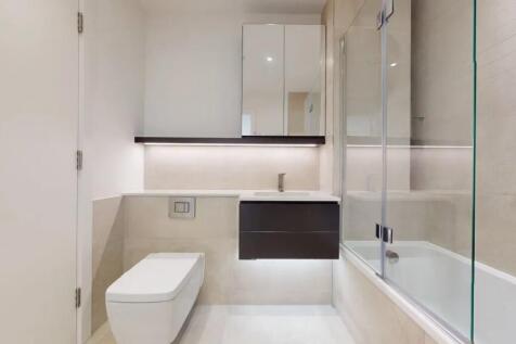 A modern and pristine bathroom suite featuring ...