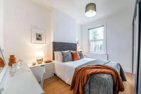 A bright and inviting master bedroom featuring ...