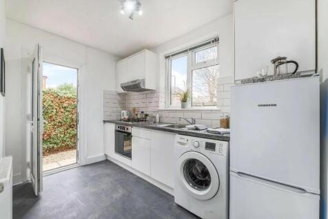 Bright and modern kitchen featuring sleek white...