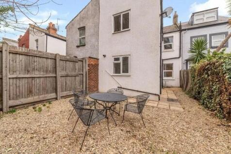 A charming enclosed garden area featuring a rou...