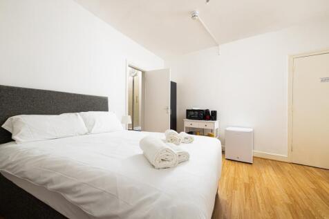 A spacious and inviting double bedroom, featuri...