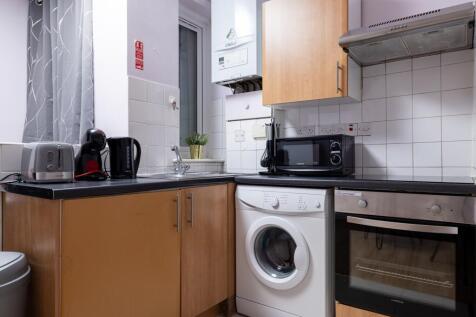 A modern kitchenette equipped with essential ap...