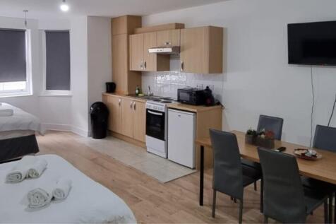 A spacious and stylish living area featuring mo...