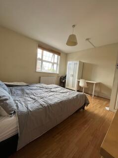 Spacious double bedroom featuring a comfortable...
