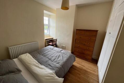 This charming double bedroom features a cozy la...