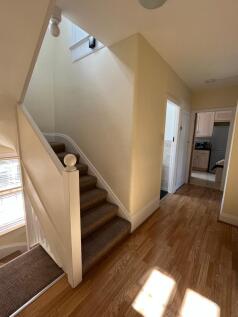 Welcoming hallway featuring natural light and w...