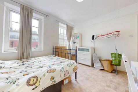Bright and airy double bedroom featuring two la...