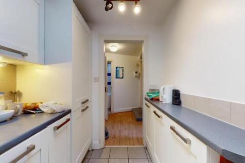 Bright and tidy kitchen featuring ample counter...