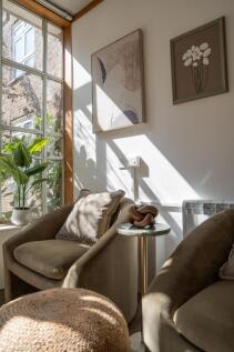 A bright and inviting living room corner featur...