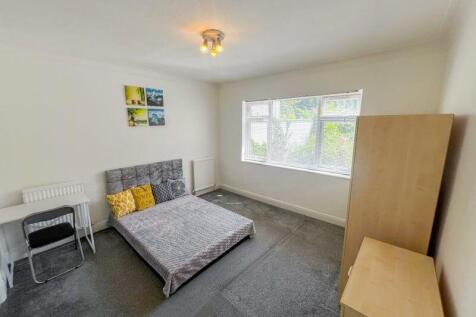 Bright and spacious bedroom featuring a comfort...