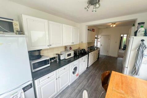 Bright and modern kitchen featuring ample cabin...