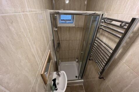 A well-maintained bathroom featuring beige tile...