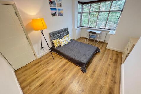 A bright and neatly arranged double bedroom fea...