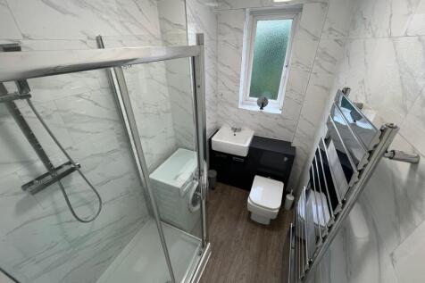Bright and modern bathroom featuring a large wa...