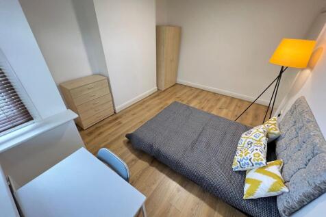 A neat and well-maintained bedroom featuring mo...