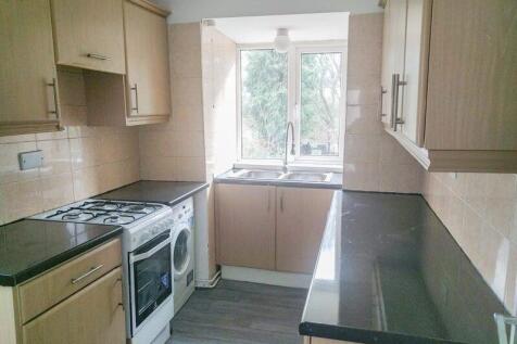 Bright and modern galley kitchen featuring ampl...