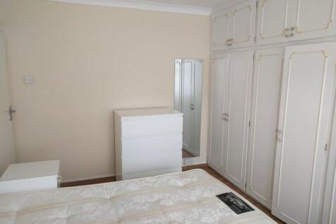 A bright double bedroom featuring clean white f...