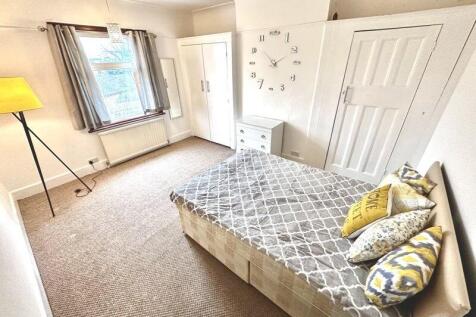 Bright and welcoming double bedroom featuring a...
