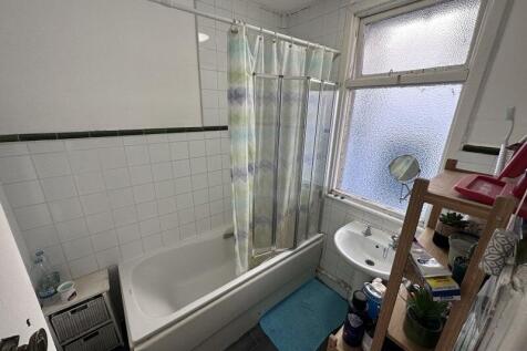 A clean and functional bathroom suite featuring...