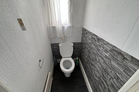 Bright and clean single toilet room featuring a...