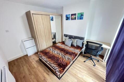 A bright, well-kept double bedroom featuring a ...