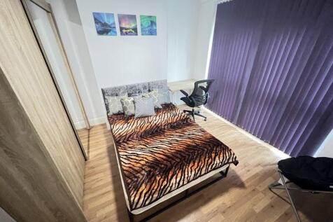 A stylish double bedroom featuring a comfortabl...